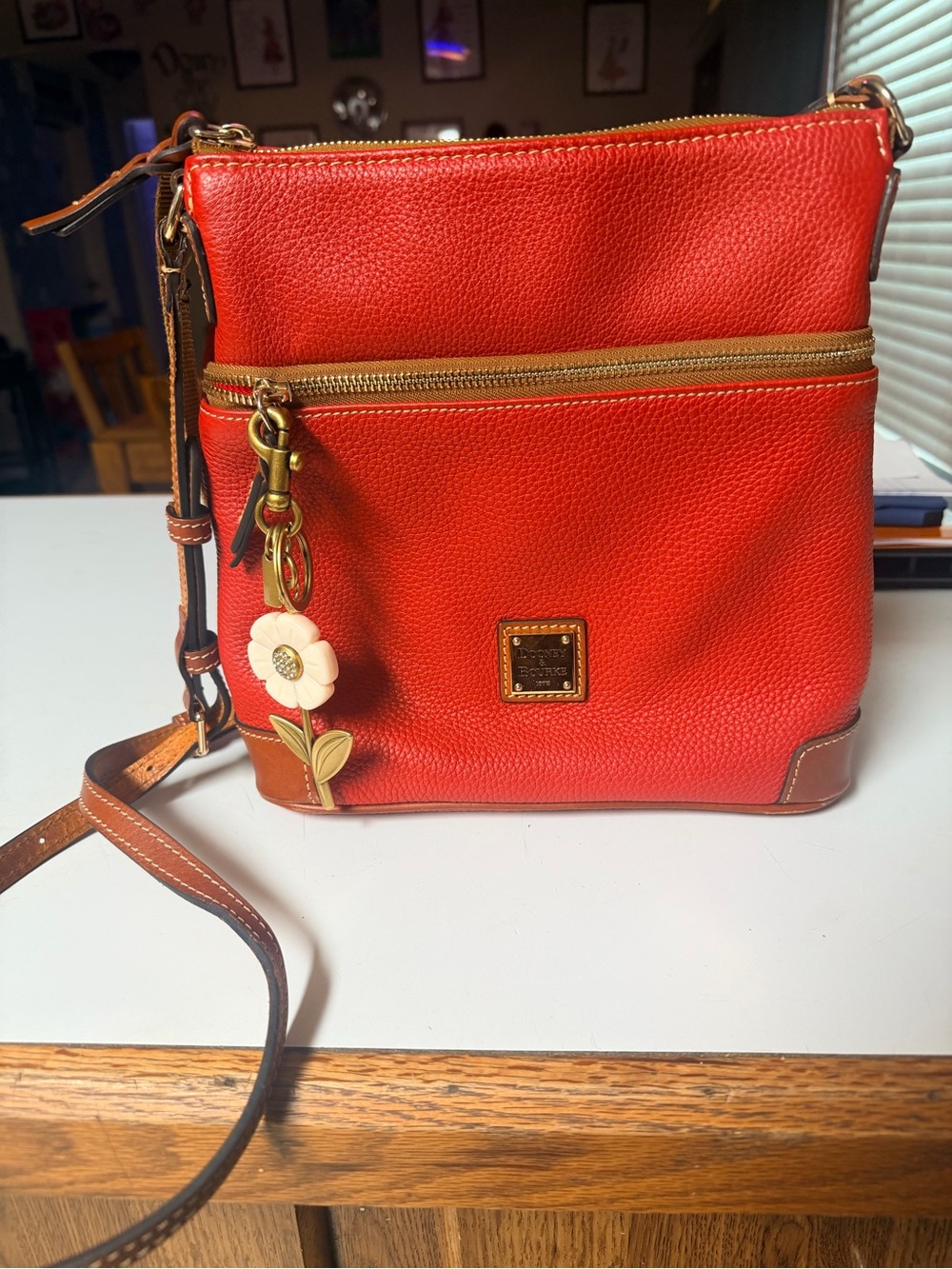 Dooney & Bourke Orange-Red Pebble Leather Crossbody with Floral Charm